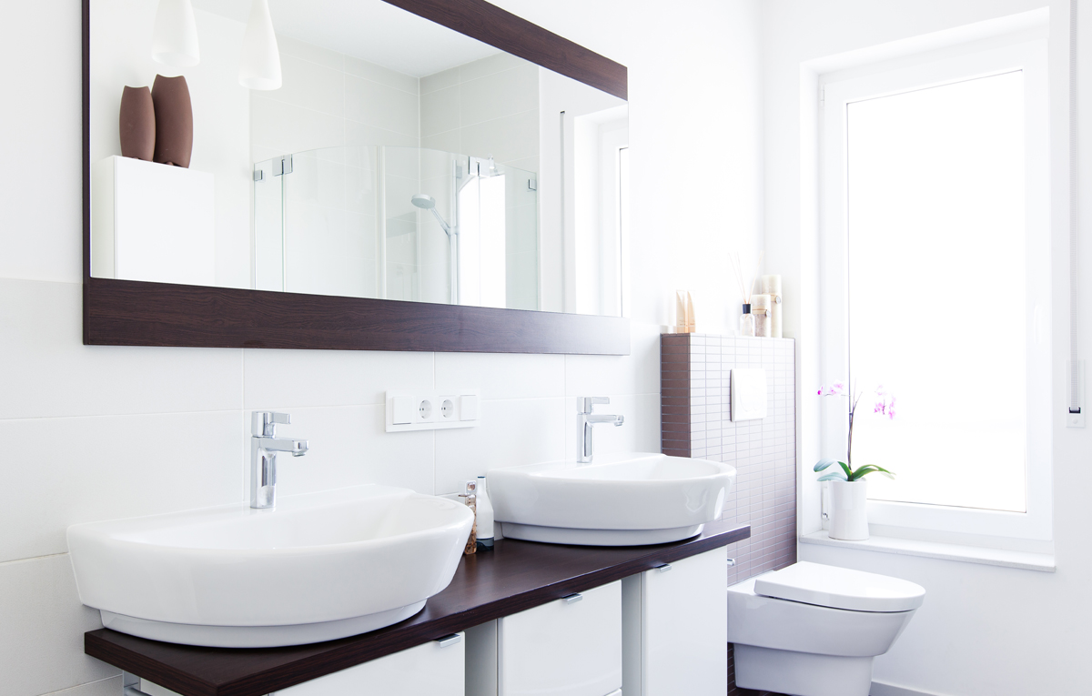 Wood framed mirror in modern bathroom.