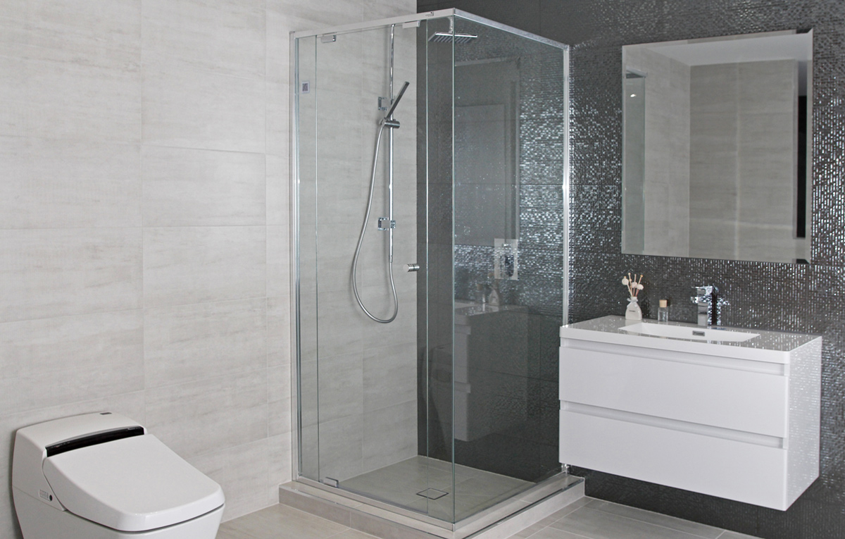 Semi frameless shower screen in modern tiled bathroom.
